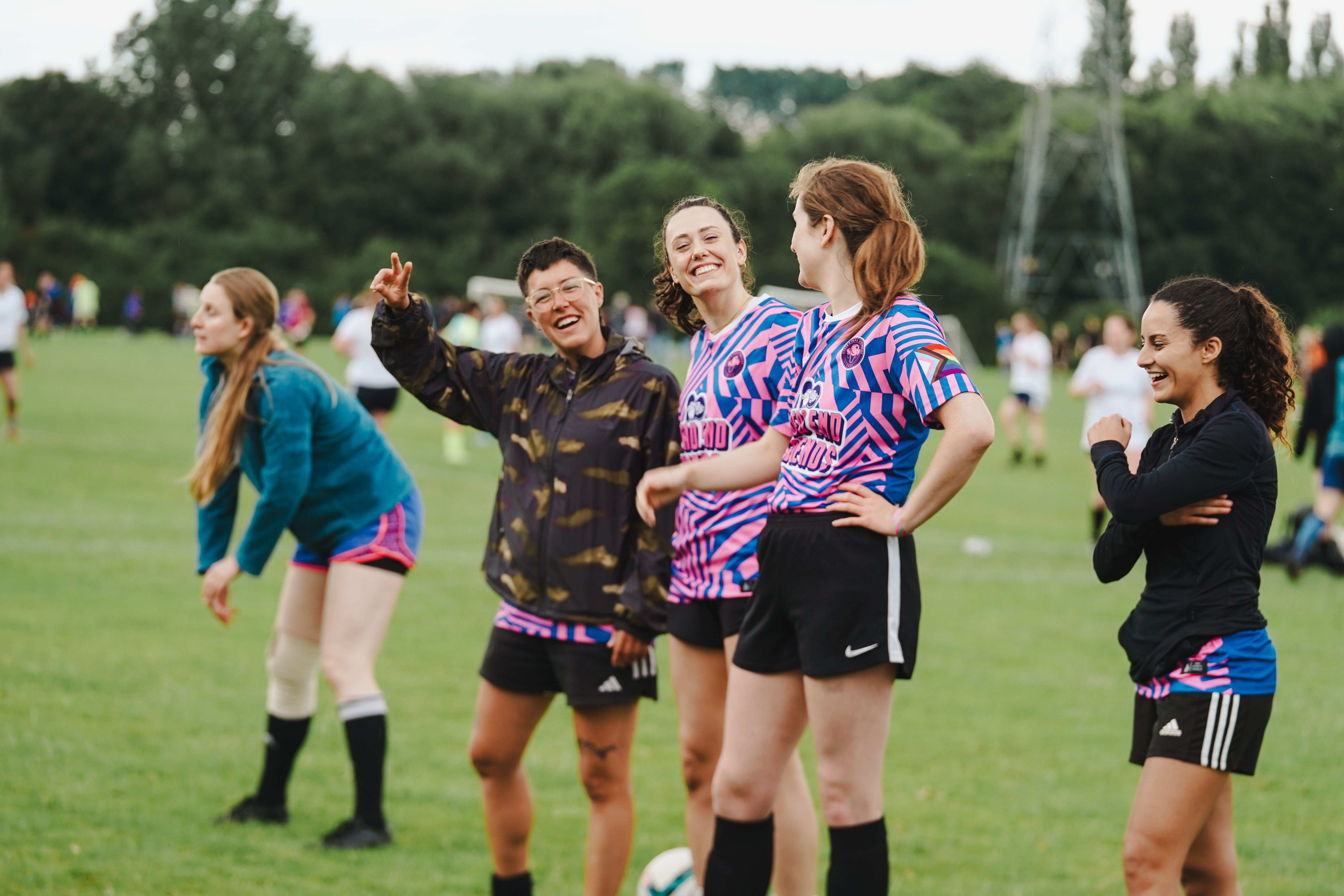 A group of players laughing with each other while watching a match